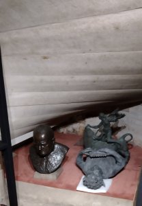 Under the stairs: Statues of Winston Churchill and Dionysis being stored together! 