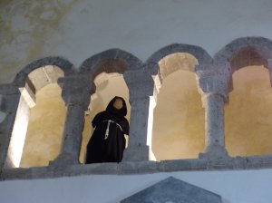 A monk peering down from the arches