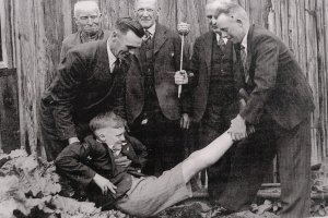 A picture of a child in the 'beating the bounds' ceremony (he doesn't seem to be enjying it much!)