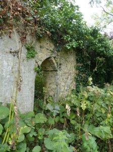 A runied wall with archway at the old priory