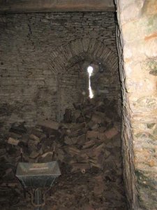 The only view of the interior- the gatehouse tower used as a woodshed.