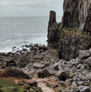 The beach by the cove , where the remains of the well cover is situated