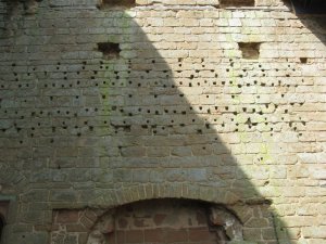 Holes that once held the pegs for the sumptuous wall coverings