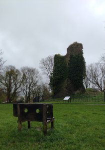 The remains of the castle and a pillory made into a bench!