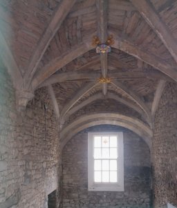 Interior of the downstairs room, showing vaulted ceiling with colourful bosses