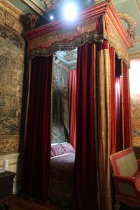 Queen Anne Bedroom, the bed was given to the Earl of Warwick by George III. It was originally in Queen Anne's bedroom at Kensington Palace, London